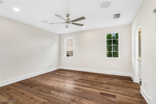 spare room featuring ceiling fan and dark hardwood / wood-style floors