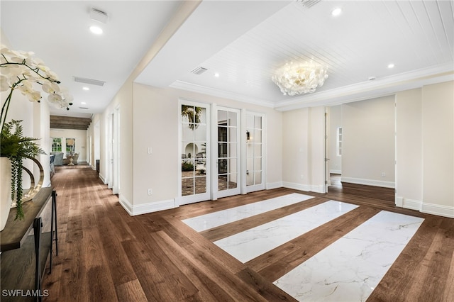 interior space featuring ornamental molding, dark wood-type flooring, a chandelier, and french doors