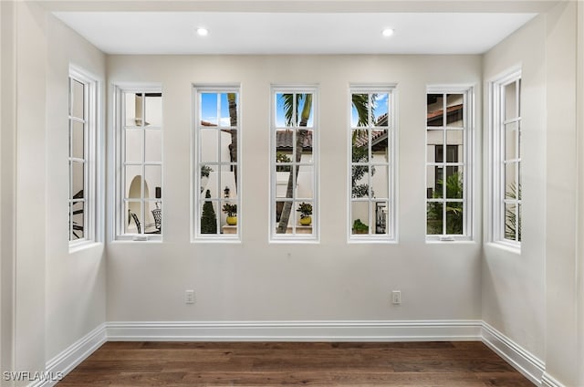 empty room with dark hardwood / wood-style floors