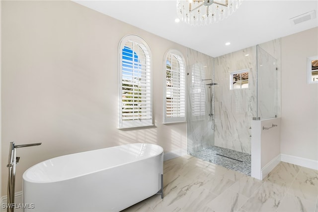 bathroom with a chandelier and plus walk in shower