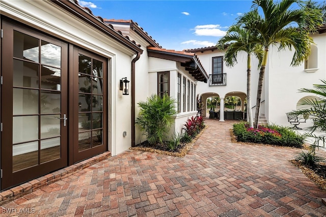 entrance to property featuring french doors and a patio area