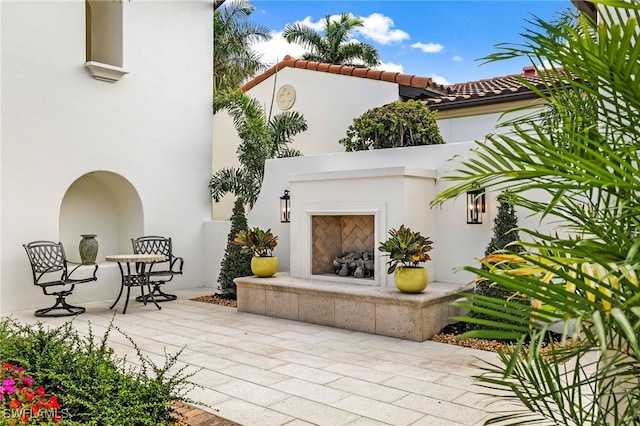 view of patio featuring exterior fireplace