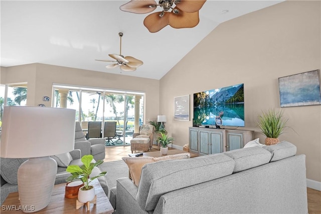 living room featuring ceiling fan and high vaulted ceiling