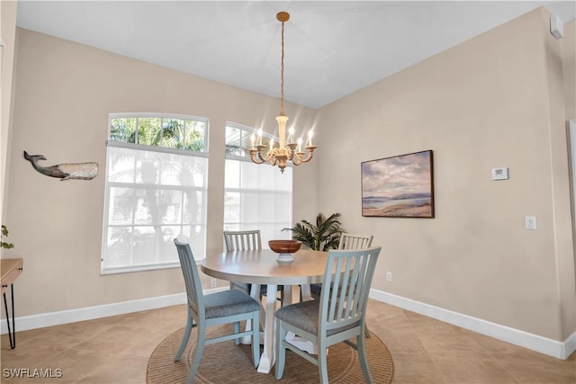 dining space with light tile patterned flooring and a chandelier