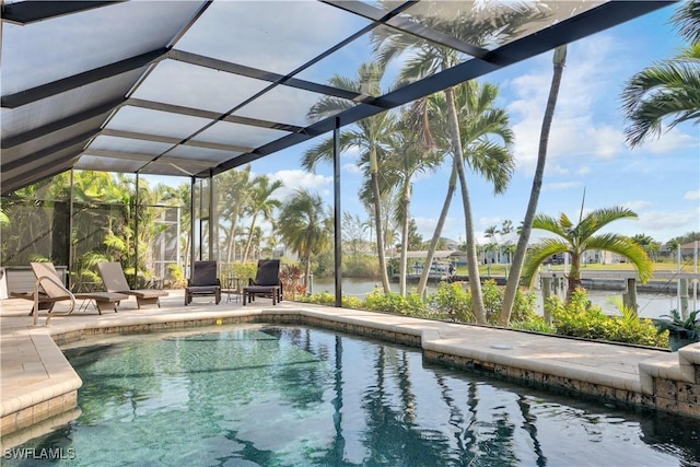 view of swimming pool featuring a patio area and glass enclosure