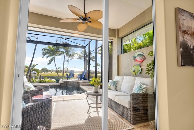 sunroom with a water view, a wealth of natural light, and ceiling fan