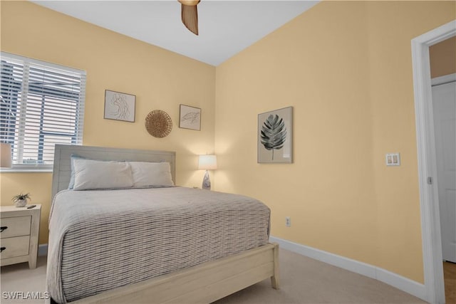 bedroom with ceiling fan and light carpet