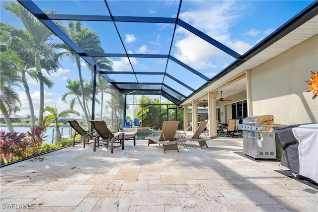 view of patio / terrace featuring a water view, ceiling fan, a grill, and a lanai