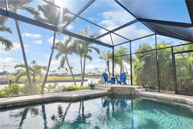 view of pool featuring a water view, a patio area, and glass enclosure