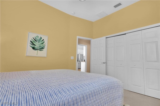 bedroom featuring light carpet and a closet