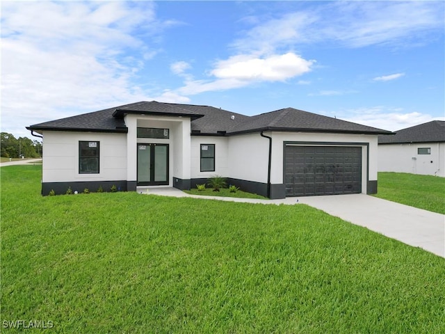 prairie-style home with a garage and a front lawn