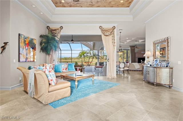 tiled living room featuring a raised ceiling, ornamental molding, a towering ceiling, and ceiling fan