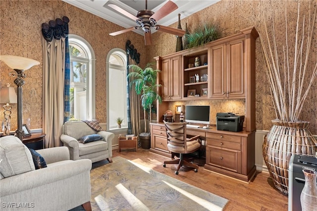 office space with crown molding, ceiling fan, and light hardwood / wood-style flooring