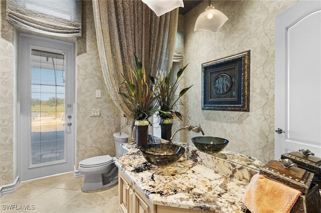 bathroom with vanity, toilet, and tile patterned flooring