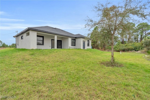 rear view of house with a yard