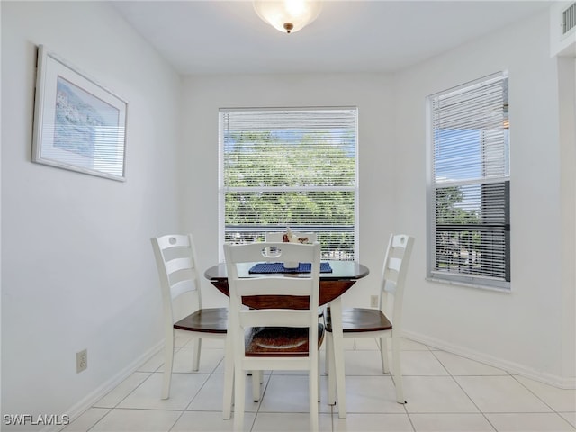 dining area with light tile patterned flooring