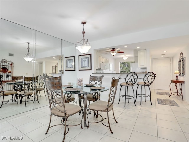 tiled dining room featuring ceiling fan