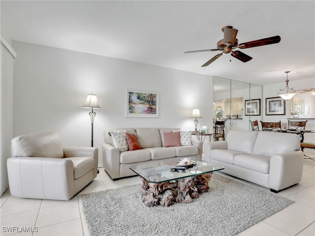 tiled living room with ceiling fan