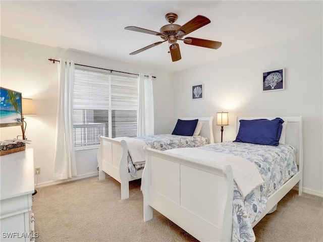 bedroom featuring light carpet and ceiling fan