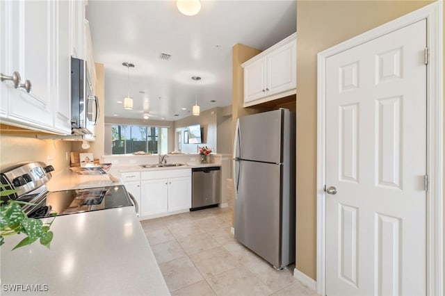 kitchen with sink, white cabinetry, hanging light fixtures, stainless steel appliances, and light tile patterned flooring