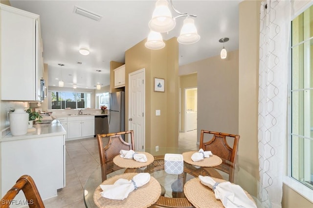 tiled dining room featuring sink