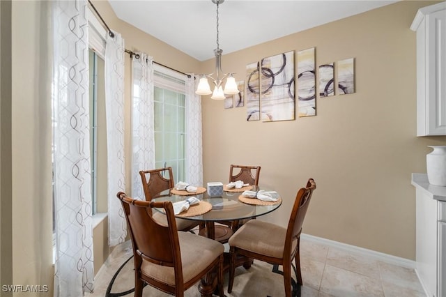 dining room with an inviting chandelier and light tile patterned floors