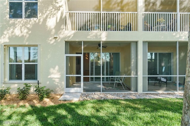 back of house featuring a patio, a balcony, a yard, and ceiling fan