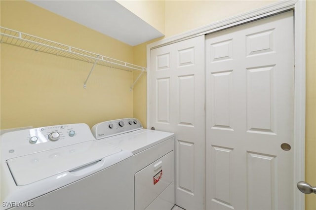 laundry room featuring washing machine and dryer