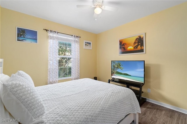 bedroom with ceiling fan and dark hardwood / wood-style flooring