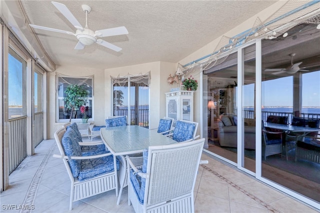 sunroom featuring ceiling fan