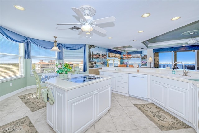 kitchen with white cabinetry, a center island, dishwasher, and cooktop