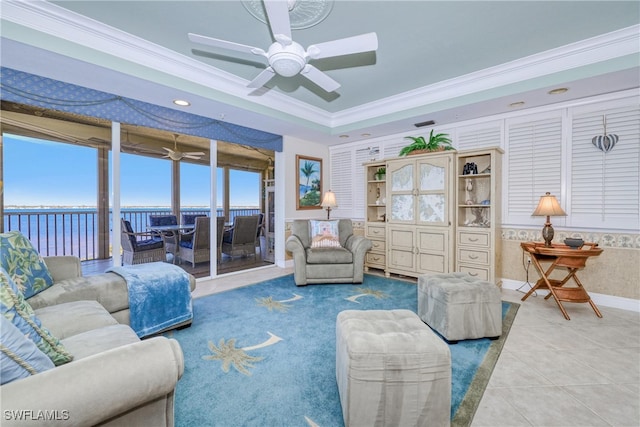 living room featuring a water view, ornamental molding, tile patterned floors, and ceiling fan