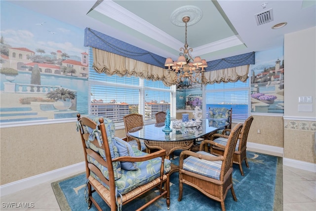 tiled dining room featuring crown molding, a notable chandelier, and a tray ceiling