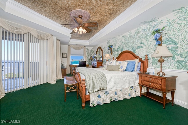 bedroom featuring crown molding, ceiling fan, a tray ceiling, and access to exterior