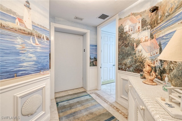 hall featuring light tile patterned floors