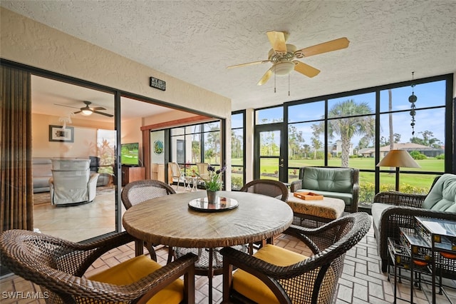 sunroom / solarium featuring ceiling fan