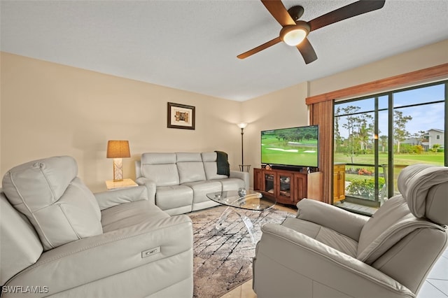 tiled living room with ceiling fan