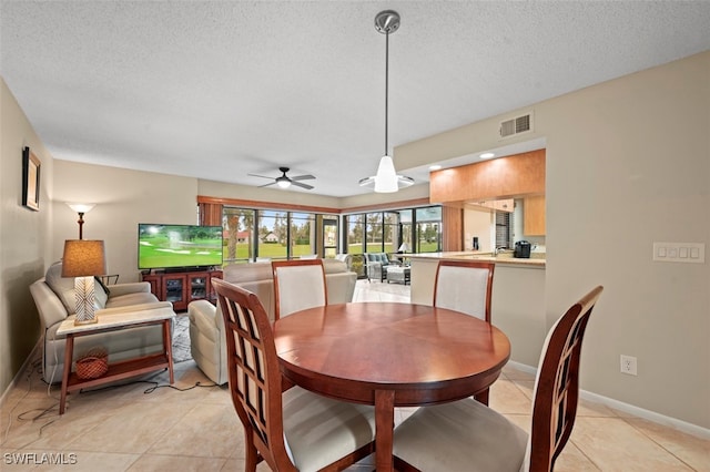 tiled dining room with a textured ceiling