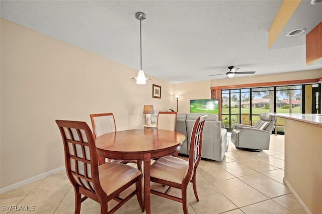 dining space featuring light tile patterned floors and ceiling fan