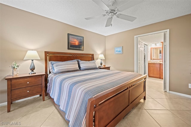 tiled bedroom with a textured ceiling, connected bathroom, and ceiling fan