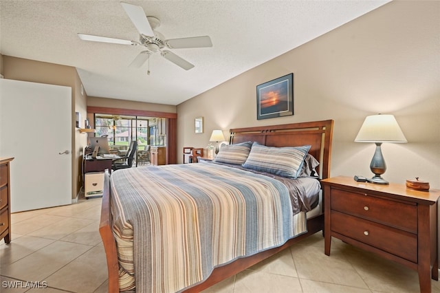 tiled bedroom with ceiling fan and a textured ceiling