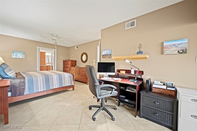 tiled bedroom featuring ceiling fan and connected bathroom