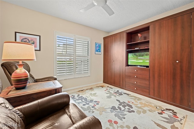 interior space with a textured ceiling, tile patterned floors, and ceiling fan