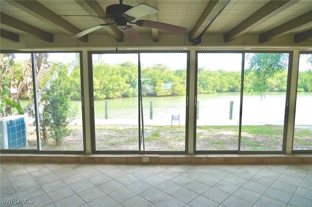 unfurnished sunroom with beam ceiling, a wealth of natural light, ceiling fan, and a water view