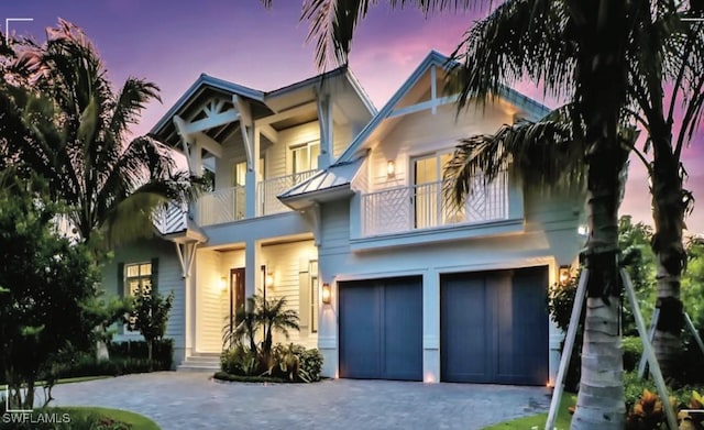 view of front of house with a garage and a balcony