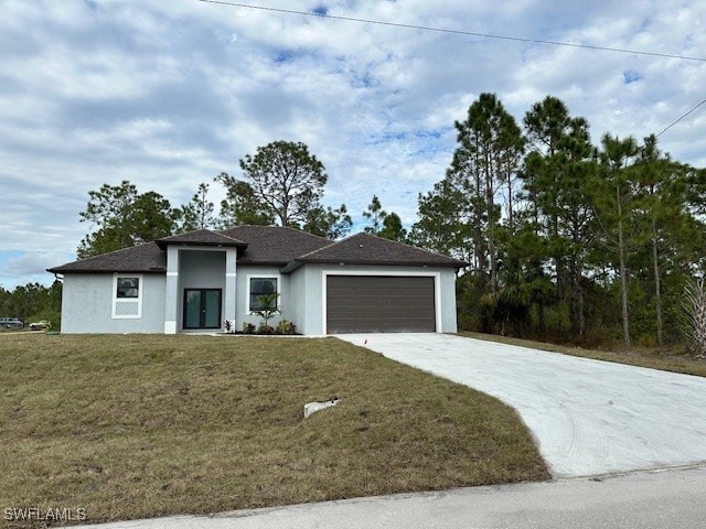 view of front of house with a garage and a front lawn