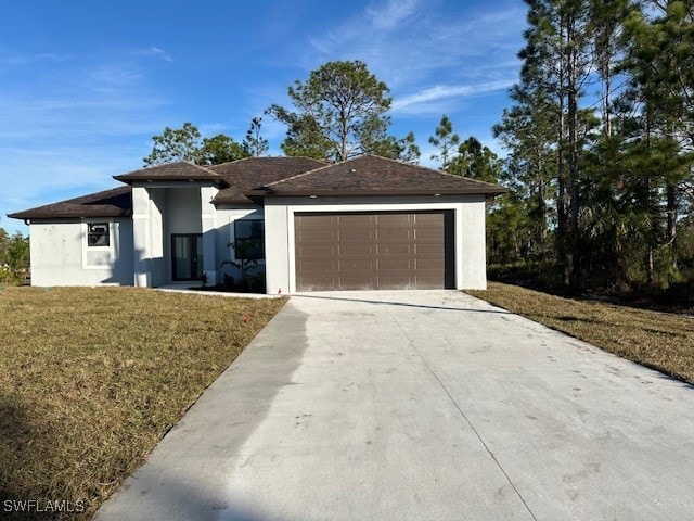 view of front of home with a front yard and a garage