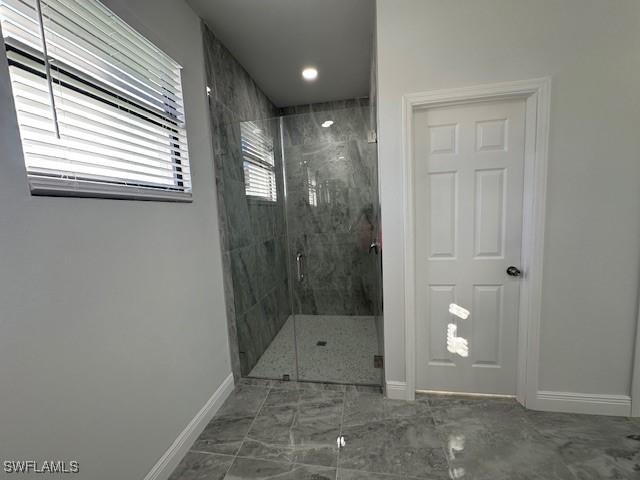 bathroom with a shower with door