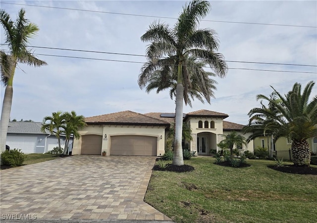 mediterranean / spanish-style house with a garage and a front yard