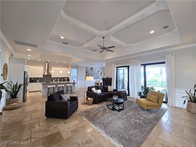 living room with crown molding, coffered ceiling, and ceiling fan